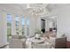Bright, airy living room with white walls, modern chandelier, and French doors to a water view at 3801 Bayshore Blvd, Tampa, FL 33611