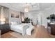 A well-lit and stylish main bedroom featuring tray ceilings, hardwood floors, artwork, and access to a balcony with a view at 3801 Bayshore Blvd, Tampa, FL 33611