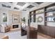 Elegant home office with custom built-ins, coffered ceilings, and a cozy fireplace at 3801 Bayshore Blvd, Tampa, FL 33611