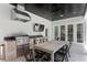 Outdoor kitchen and dining area featuring a built-in grill, stainless steel hood, and bar seating at 3801 Bayshore Blvd, Tampa, FL 33611