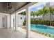 Beautiful patio with pool view featuring tiled flooring, white pillars, and a ceiling fan at 3801 Bayshore Blvd, Tampa, FL 33611