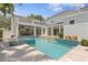 Stunning backyard pool and patio area with an outdoor kitchen and stylish tiled pool at 3801 Bayshore Blvd, Tampa, FL 33611