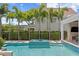 Backyard pool features blue tile, palm trees, and a well-manicured lawn at 3801 Bayshore Blvd, Tampa, FL 33611