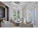 Bright sitting room with natural light, elegant chandelier, and views of the backyard at 3801 Bayshore Blvd, Tampa, FL 33611