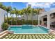 Beautiful backyard swimming pool and spa area surrounded by lush landscaping at 3801 Bayshore Blvd, Tampa, FL 33611