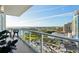 Balcony featuring glass railings and stunning city skyline views, with comfortable outdoor seating at 400 Beach Ne Dr # 1202, St Petersburg, FL 33701