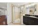 Bathroom featuring a walk-in shower with glass enclosure, black vanity, and modern fixtures at 400 Beach Ne Dr # 1202, St Petersburg, FL 33701