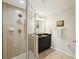 Bathroom featuring a glass enclosed shower with tile surround and black vanity at 400 Beach Ne Dr # 1202, St Petersburg, FL 33701