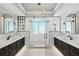 Stunning bathroom with dual vanities, a glass shower enclosure, and modern lighting fixtures at 400 Beach Ne Dr # 1202, St Petersburg, FL 33701