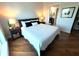 Cozy bedroom boasts a queen-sized bed with stylish nightstands, lamps, and ensuite bathroom access at 400 Beach Ne Dr # 1202, St Petersburg, FL 33701