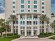 Grand building entrance with lush landscaping, palm trees, and elegant architectural details at 400 Beach Ne Dr # 1202, St Petersburg, FL 33701
