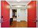 Grand entrance with striking red doors leading to elevators and a seating area at 400 Beach Ne Dr # 1202, St Petersburg, FL 33701