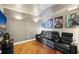 A home theater features leather seating, movie posters, and hardwood floors for entertainment at 400 Beach Ne Dr # 1202, St Petersburg, FL 33701