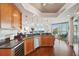 Bright kitchen features wood cabinets, stainless appliances, granite countertops and open view of adjacent living area at 400 Beach Ne Dr # 1202, St Petersburg, FL 33701