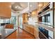Modern kitchen boasts stainless steel appliances and wood cabinets with granite countertops at 400 Beach Ne Dr # 1202, St Petersburg, FL 33701