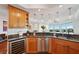 Gourmet kitchen boasts wood cabinetry, a wine cooler, stainless steel appliances, and eat-in breakfast bar at 400 Beach Ne Dr # 1202, St Petersburg, FL 33701