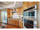 Modern kitchen featuring stainless steel appliances, wooden cabinets, and granite countertops at 400 Beach Ne Dr # 1202, St Petersburg, FL 33701