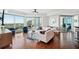Bright living room with floor-to-ceiling windows and modern furnishings overlooking the city and ocean at 400 Beach Ne Dr # 1202, St Petersburg, FL 33701