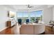 Bright living room with floor-to-ceiling windows and modern furnishings overlooking the city and ocean at 400 Beach Ne Dr # 1202, St Petersburg, FL 33701