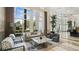 Bright living room featuring large windows with a view of the lush landscaping at 400 Beach Ne Dr # 1202, St Petersburg, FL 33701