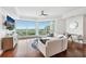 Bright living room features a curved sofa, modern furniture, and expansive windows with a scenic view at 400 Beach Ne Dr # 1202, St Petersburg, FL 33701