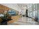 Grand lobby with high ceilings, wood accents, modern art, and marble floors at 400 Beach Ne Dr # 1202, St Petersburg, FL 33701