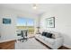 Bright office featuring a large window, hardwood floors, white couch, and grey rug at 400 Beach Ne Dr # 1202, St Petersburg, FL 33701