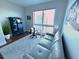 Bright home office featuring a convertible couch, desk, and large window offering expansive city views at 400 Beach Ne Dr # 1202, St Petersburg, FL 33701