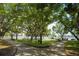 Green park with walking paths, large trees, park benches, and views of water in the background at 400 Beach Ne Dr # 1202, St Petersburg, FL 33701
