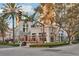 Exterior of a local restaurant with an outdoor patio, lush greenery, and street views at 400 Beach Ne Dr # 1202, St Petersburg, FL 33701