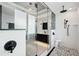 Modern shower featuring black hardware, rain shower head, river rock floor and tile walls at 400 Beach Ne Dr # 1202, St Petersburg, FL 33701