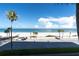 Beach scene featuring palm trees and a distant car at 403 Gulf Way # 302, St Pete Beach, FL 33706