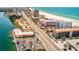 Coastal aerial view of a town with a beach along the ocean and buildings nearby at 4103 Gulf Blvd # 205, St Pete Beach, FL 33706