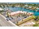 Aerial shot of a waterfront building with parking and boat docks along the bay at 4103 Gulf Blvd # 205, St Pete Beach, FL 33706