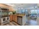 Open-concept kitchen with stainless steel appliances, breakfast bar, and hardwood floors at 4103 Gulf Blvd # 205, St Pete Beach, FL 33706