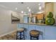 Inviting kitchen breakfast bar with granite countertops, pendant lighting, and seating at 4103 Gulf Blvd # 205, St Pete Beach, FL 33706