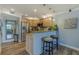 Charming kitchen with stainless steel appliances, breakfast bar, and tile backsplash at 4103 Gulf Blvd # 205, St Pete Beach, FL 33706