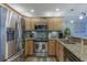 Well-equipped kitchen featuring stainless steel refrigerator, oven, and granite countertops at 4103 Gulf Blvd # 205, St Pete Beach, FL 33706