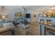 Comfortable living room, featuring a sofa set, TV, and breakfast bar with stools at 4103 Gulf Blvd # 205, St Pete Beach, FL 33706