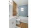 Modern bathroom with blue tile, wood accents, and updated fixtures at 411 Virginia Ave, Brooksville, FL 34601