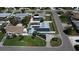 Aerial view of home with pool, screened-in patio, fenced yard, and solar panels on the roof at 4301 50Th S Ter, St Petersburg, FL 33711