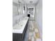 Bright bathroom featuring double sinks, stone mat, large mirror, and updated fixtures at 4301 50Th S Ter, St Petersburg, FL 33711