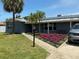 Charming home with well-maintained lawn, beautiful flower beds, solar panels, and inviting walkway at 4301 50Th S Ter, St Petersburg, FL 33711