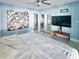 Airy main bedroom with modern decor, a ceiling fan, and convenient access to the bathroom at 4301 50Th S Ter, St Petersburg, FL 33711