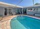 Gorgeous in-ground pool is surrounded by brick pavers and ample seating for relaxing poolside at 4301 50Th S Ter, St Petersburg, FL 33711