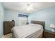 Cozy bedroom featuring a comfortable bed with striped bedding and light blue walls at 4319 Tahitian Gardens Cir # E, Holiday, FL 34691