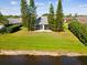 Aerial view of home featuring a spacious backyard, screened in porch, and pond at 4320 Northampton Dr, New Port Richey, FL 34653