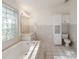 Bathroom features tile floors, a step-up tub, and a separate shower stall at 4320 Northampton Dr, New Port Richey, FL 34653