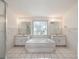 A bathroom with a step-up tub, dual sinks, and a tiled floor at 4320 Northampton Dr, New Port Richey, FL 34653
