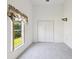 A carpeted bedroom with a closet and a leafy view from the window at 4320 Northampton Dr, New Port Richey, FL 34653